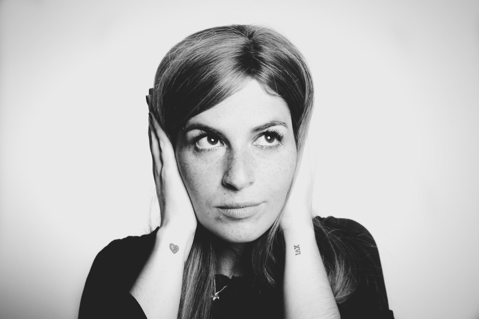 close up photo of woman covering her ears